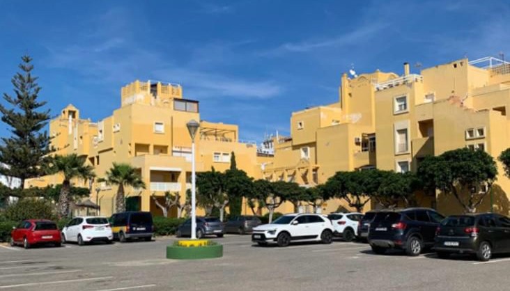 Modern apartment building with balconies and a pool near the beach in Roquetas de Mar