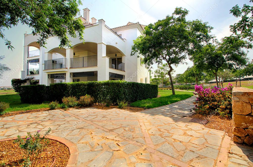 Apartment terrace overlooking a golf course and pool in Almería