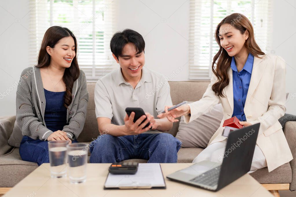 Agent explaining property documents to clients at a desk